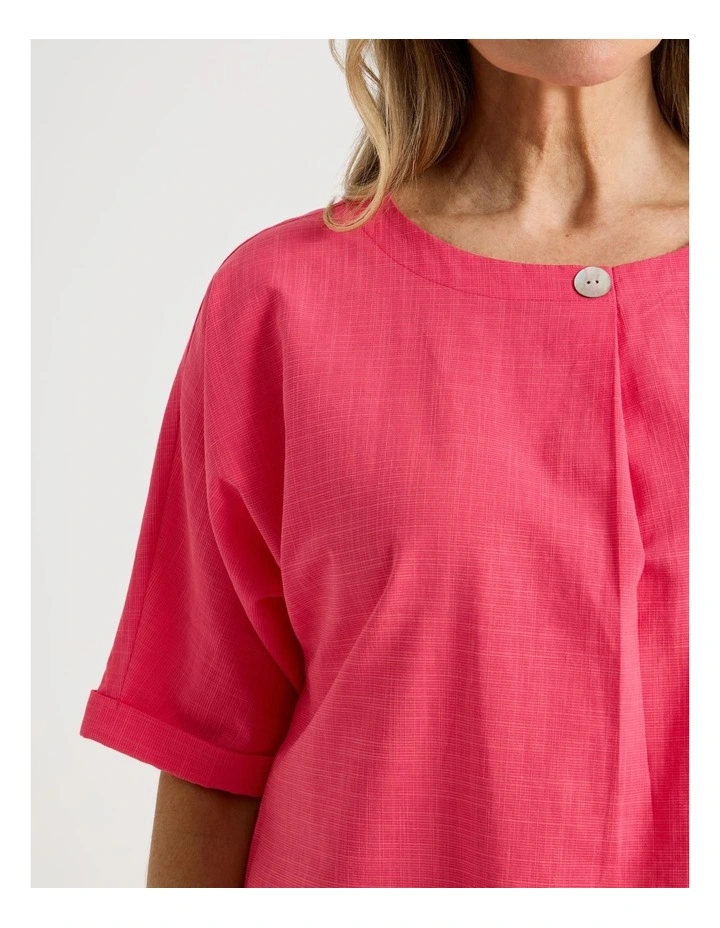 Extended Short Sleeve Top With Front Pleat & Button in Coral image 3