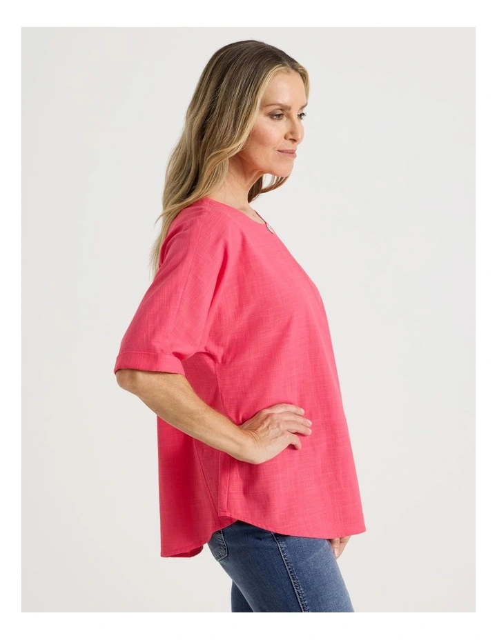 Extended Short Sleeve Top With Front Pleat & Button in Coral image 4