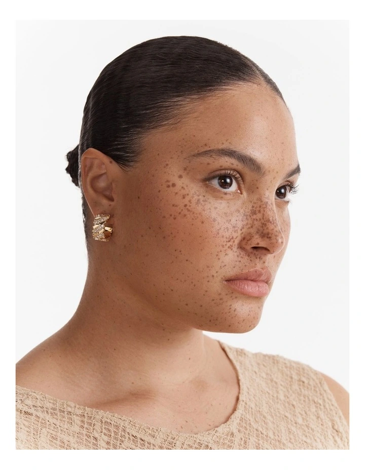 Winked Huggie Hoop Earrings in Gold image 4